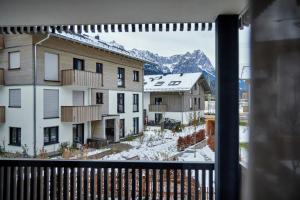 a view from a balcony with snow covered buildings at Wax-N-Stein in Garmisch-Partenkirchen