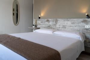 Postel nebo postele na pokoji v ubytování Hotel Mom Assisi