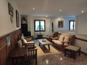 a living room with a couch and chairs and a table at Hotel Solatorre in Comillas