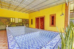 a bathroom with blue and white tiles on the floor at OYO 92367 Garuda Homestay Syariah in Banyuwangi