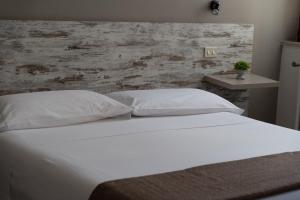 Postel nebo postele na pokoji v ubytování Hotel Mom Assisi