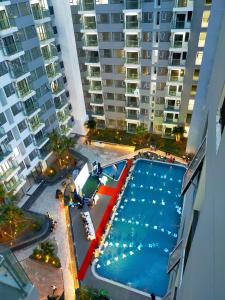 an overhead view of a swimming pool with tall buildings at Noric homestay in Hue