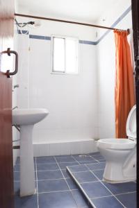 a bathroom with a toilet and a sink at Bridge Hotel Mombasa in Mombasa