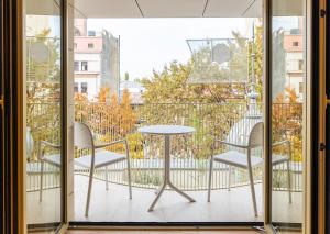 a balcony with a table and chairs on a balcony at Rosetti Hotel in Bucharest