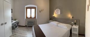 Postel nebo postele na pokoji v ubytování Hotel Mom Assisi