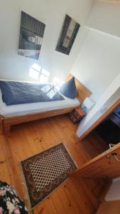 a room with a bed on a wooden floor at Ferienwohnung im Bückle in Gottenheim