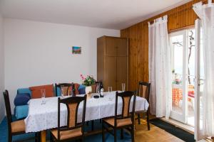 a dining room with a white table and chairs at Apartment Angelina in Dubrovnik