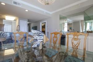 a dining room and kitchen with a table and chairs at Incredible Great Deals On This Hidden Gem Gulf Front Condo at The Pearl Sleeps 8 in Navarre