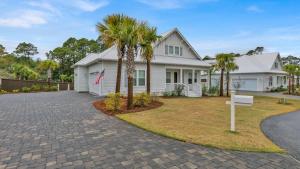 una casa blanca con palmeras en la entrada en Alluring Private Pool Sweet Haven at Dune Allen, en Santa Rosa Beach