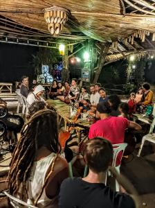 een groep mensen die aan tafel zitten in een restaurant bij KRABI BAMBOO KINGDOM at AOLUEK PARADISE in Ao Luk