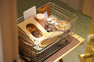 a wire basket with a box of donuts on a table at hotel hisoca ikebukuro in Tokyo