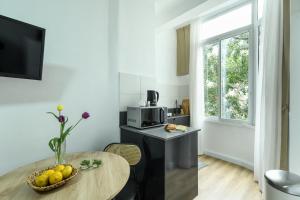 a kitchen with a table with a bowl of fruit on it at Cozy 1BR Studio Apartment in Heart of Tel Aviv by Sea N' Rent in Tel Aviv