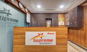 a sign for a supreme restaurant on a wall at Treebo Vetri Supreme Residency in Chennai