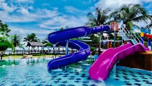 a water slide in a pool at a resort at De Baron Resort in Kuah