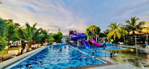 a pool at a resort with a water slide at De Baron Resort in Kuah