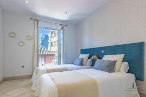 Posteľ alebo postele v izbe v ubytovaní Living4Malaga Majestic Granada Street