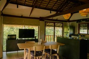 a kitchen and dining room with a table and chairs at Domu Mia Villa Siargao in General Luna