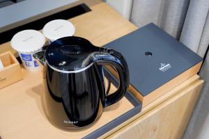 a black appliance sitting on top of a table at Eden Foret Hotel in Chungju