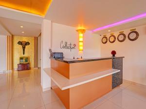 a lobby of a hotel with a reception counter at Pallava Rajadhani in Trivandrum