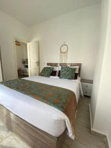 a bedroom with a large bed with a clock on the wall at Elegant Stay in Hurghada