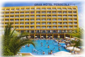 a hotel with a large swimming pool with people in it at Gran Hotel Peñiscola in Peniscola