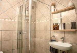 a bathroom with a shower and a sink at Paradise Self-Catering Units in Jeffreys Bay