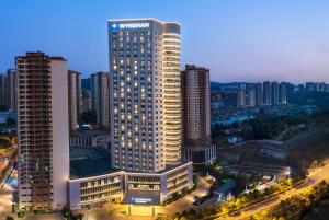 a large building in a city with tall buildings at Kunming Huiyue Wyndham Hotel in Kunming