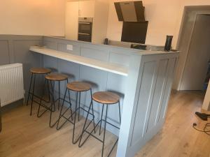 a kitchen with a counter with stools around it at DS Study or Visit in Dundee