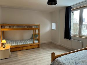 a bedroom with two bunk beds and a window at Appartement 6/8 personnes 