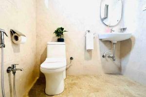 a bathroom with a toilet and a sink at BluO 1BHK Gachibowli - Terrace Garden, Lift in Hyderabad