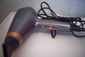 a hair dryer with a cord hooked up to it at Casa Alex by Wonderful Italy in Gera Lario