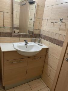 y baño con lavabo y espejo. en Stunning 1-Bed Apartment in Larnaca near the sea, en Perivolia