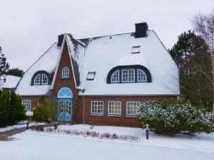 a house with snow on the roof at Schaar in Nebel