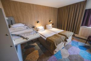 Voodi või voodid majutusasutuse Quality Hotel Royal Corner toas