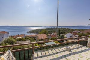 a view of the water from the balcony of a house at Apartments Dragica in Dramalj