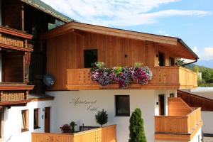 a building with flower boxes on the balcony at Apartment Edith in Telfes im Stubai
