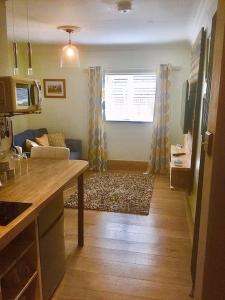 a kitchen and living room with a couch and a table at HENWICK HOUSE Beautiful flat,Private parking, short walk to town in Ludlow