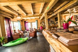 博维茨索佳洛克斯旅馆的一间大房间，里面有一个酒吧，人们坐在椅子上