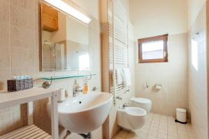 a white bathroom with a sink and a toilet at Apartment Alexander by MoniCare in Seefeld in Tirol