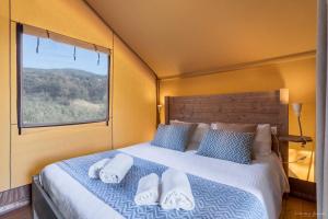ein Schlafzimmer mit einem Bett mit Kissen und einem Fenster in der Unterkunft Podere Cortesi in Santa Luce