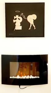 a picture of a person standing next to a fireplace at River View & Close to the Beach - Quarto em Almada in Almada