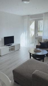 sala de estar con sofá y TV en Ferienwohnung Frieda, en Delmenhorst