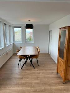 a dining room with a wooden table and chairs at Air Apartments 9 in Bremen