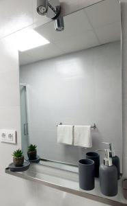 a bathroom with a mirror and a sink at Playa Doñana 2 in Sanlúcar de Barrameda