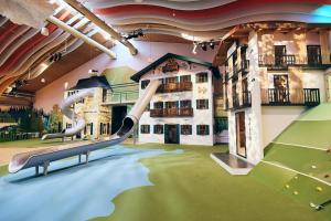 a indoor playground with a slide in a building at Bachmair Weissach See-Apartments in Rottach-Egern
