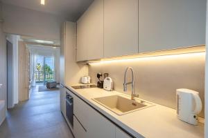 a kitchen with a sink and a counter top at Calypso beach front apartment in Hanioti