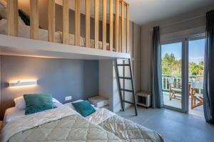 a bedroom with a bunk bed and a ladder at Calypso beach front apartment in Hanioti