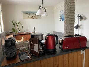 a kitchen counter with a coffee maker and a toaster at L améthystes in Crozon