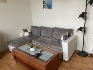 a living room with a couch and a coffee table at L améthystes in Crozon