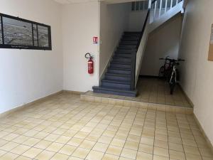 a room with a staircase and a bike parked in it at L améthystes in Crozon